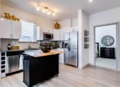 Thumbnail 1 of 35 - a kitchen with a large island and stainless steel appliances at East 51 At Rocketts Landing, Richmond, 23231