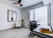 Thumbnail 18 of 35 - an office with a large window and a ceiling fan at East 51 At Rocketts Landing, Richmond, 23231