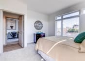 Thumbnail 31 of 35 - a bedroom with a large bed and a large window at East 51 At Rocketts Landing, Richmond, 23231