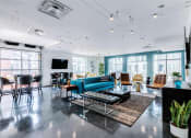 Thumbnail 19 of 35 - a living room with a blue couch and chairs at East 51 At Rocketts Landing, Richmond, 23231