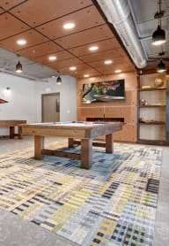 a games room with two pool tables and a foosball table