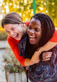 Two women hugging each other in a park.