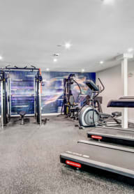 a gym with treadmills and other exercise equipment