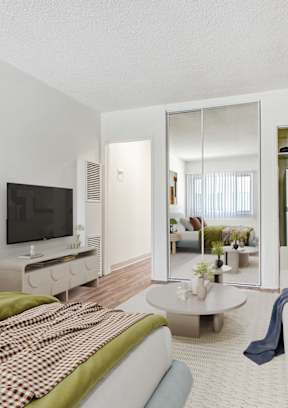 a living room with a couch and a bed and a tv