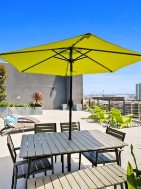a patio with a table and chairs under an umbrella