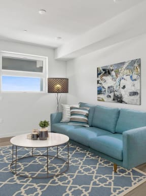 a living room with white walls and a blue couch