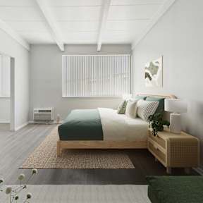 A bedroom with a bed, nightstand, and chair.