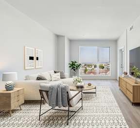 A living room with a couch, a chair, a coffee table, and a television.