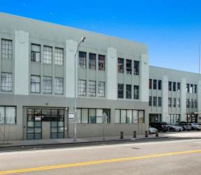 a large white building with many windows on a street