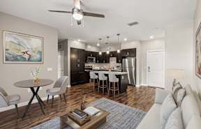 A modern kitchen with a central island and bar stools.