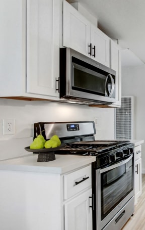 a kitchen with stainless steel appliances and white cabinets