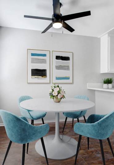a dining room with a table and chairs and a ceiling fan