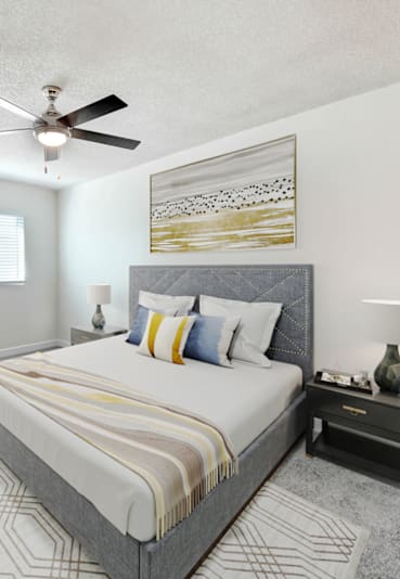 a bedroom with a large bed and a ceiling fan