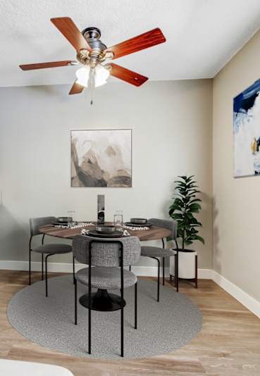 A dining room with a table set for four.