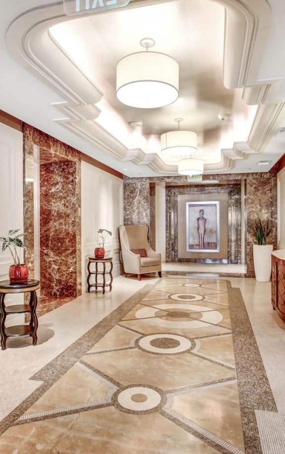 a hallway with chairs and a television and a rug