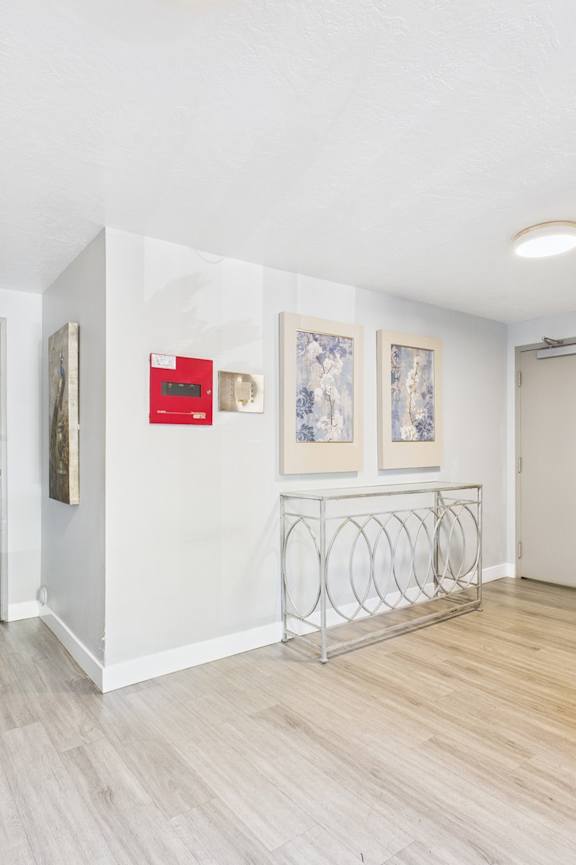 A hallway with a white exit sign above the door.