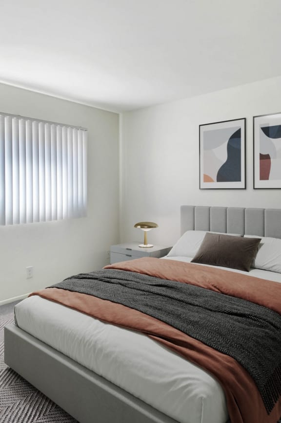 an example of a bedroom with a bed and a potted plant