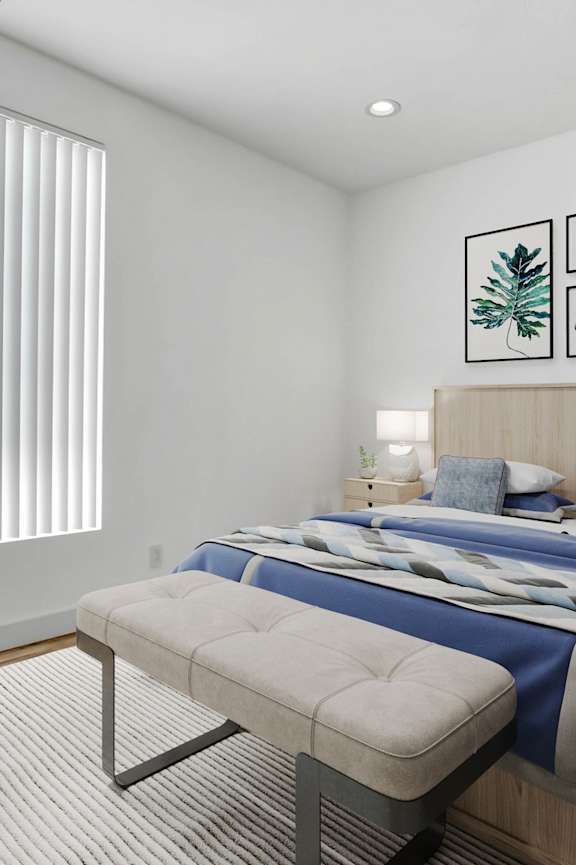 a bedroom with a bed and a window with white blinds