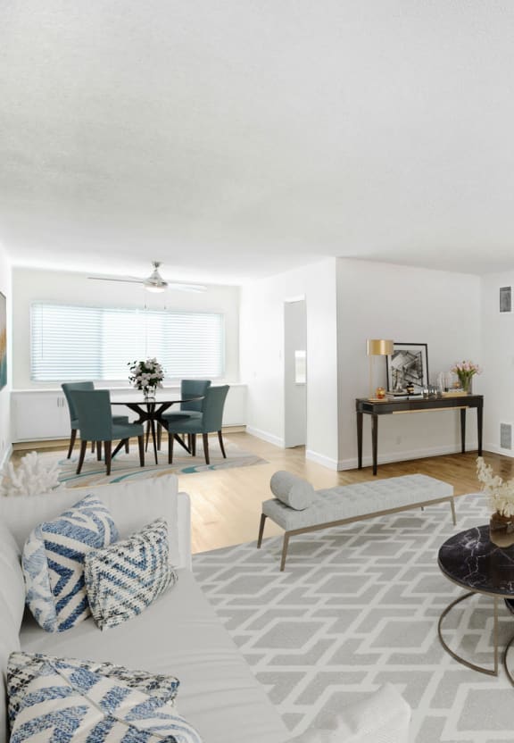 an empty living room with a ceiling fan and a window