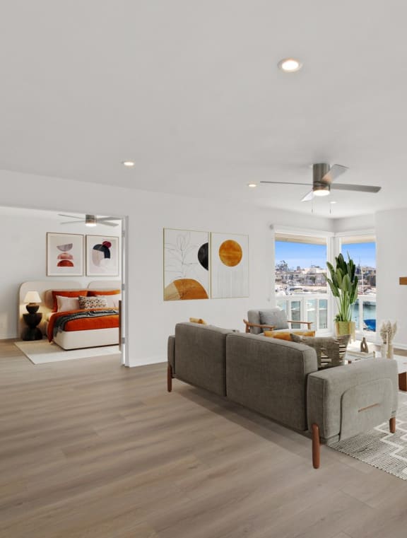 a living room with white couches and a fireplace