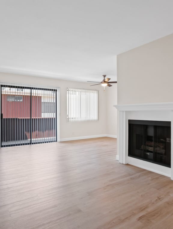 a living room with hardwood floors and a fireplace