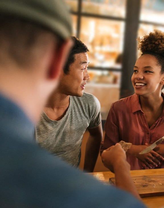 a group of people sitting at a table talking