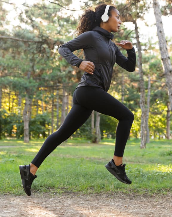 a woman running in a park