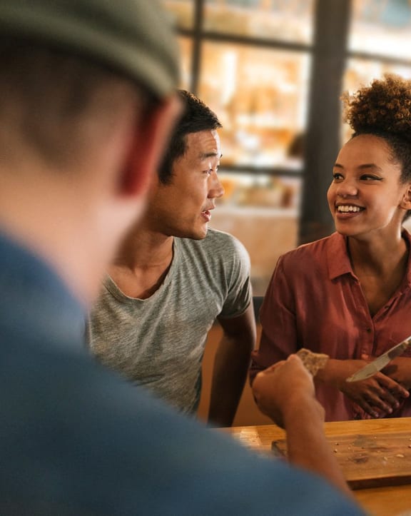 a group of people sitting at a table talking