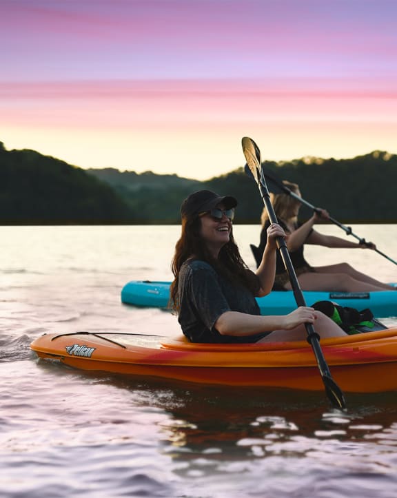 Two women kayaking in water