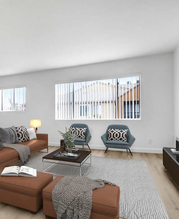 A living room with a brown couch, a grey couch, a coffee table, and a television.