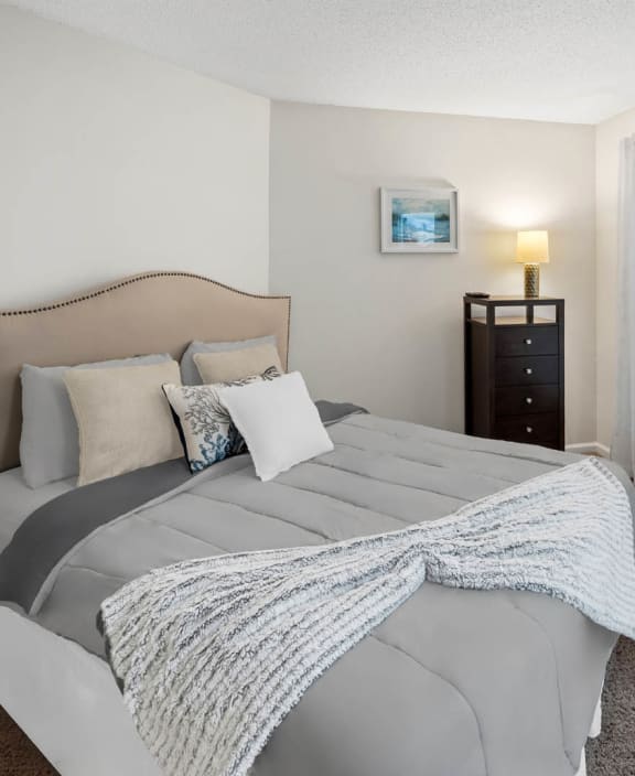 a bedroom with a bed and a large window at University Ridge Apartments, Durham, North Carolina, 27707