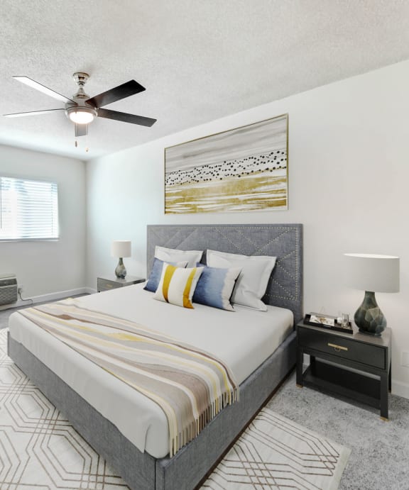 a bedroom with a large bed and a ceiling fan