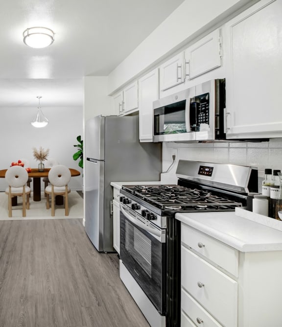 a kitchen with stainless steel appliances and white cabinets