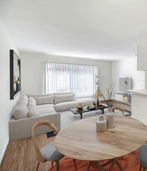 a living room with a table and a couch and a kitchen