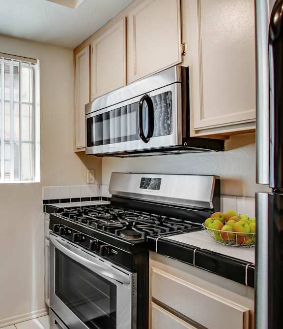 a kitchen with a stove top oven next to a window