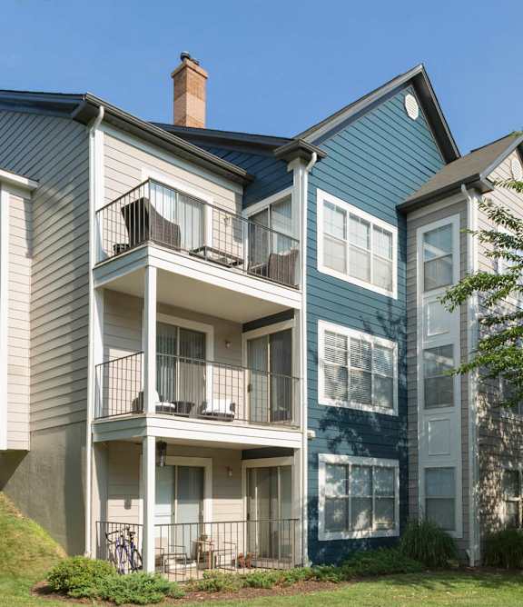 A two story house with a balcony on the second floor at Heritage at Waters Landing, Germantown, MD, 20874