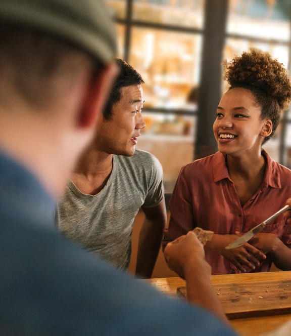 a group of people sitting at a table talking