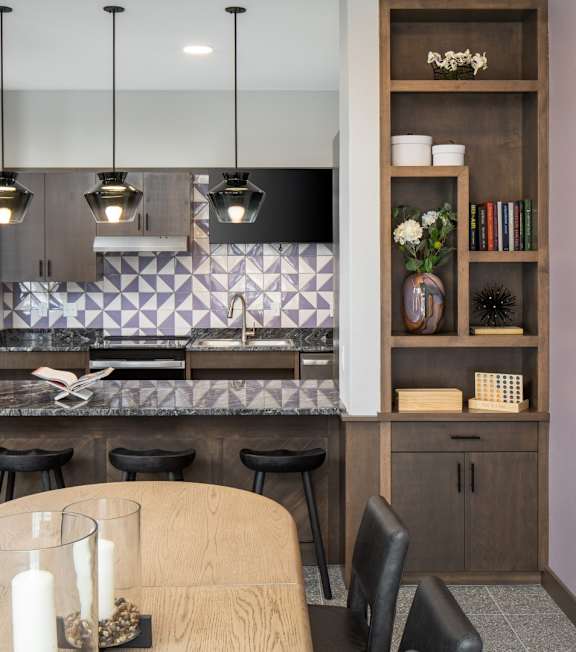 A modern dining room with a wooden table and chairs.at The Edison at Woodbury, Minnesota