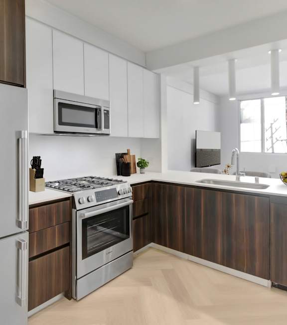 A modern kitchen with a stainless steel refrigerator and wooden cabinets.