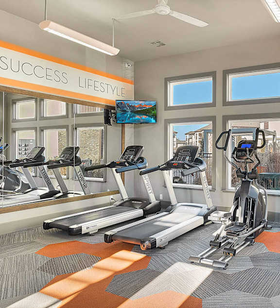 A gym with treadmills and exercise equipment.