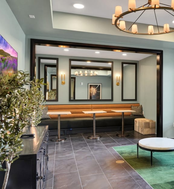 a living room with a couch and a table and a chandelier