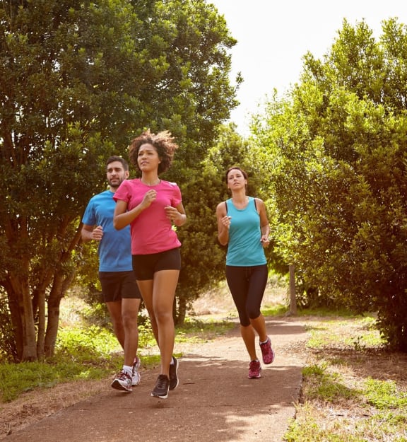 a group of women running in the park