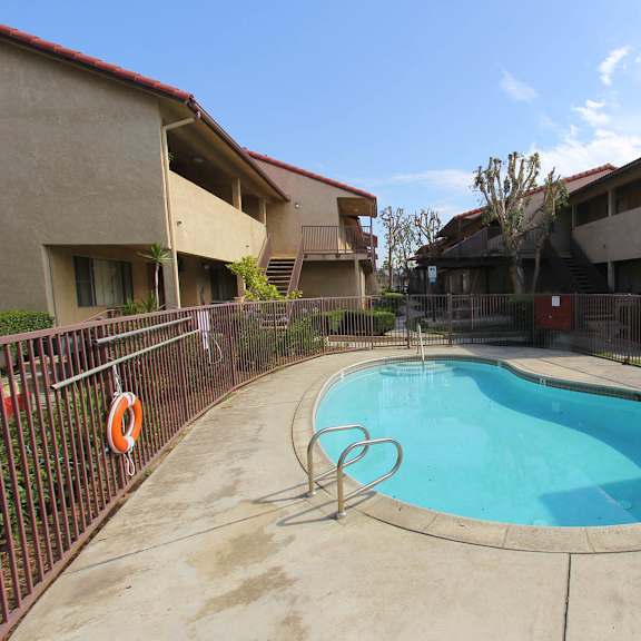The front of the Mesa Vista Apartments building with a flag flying in the background.