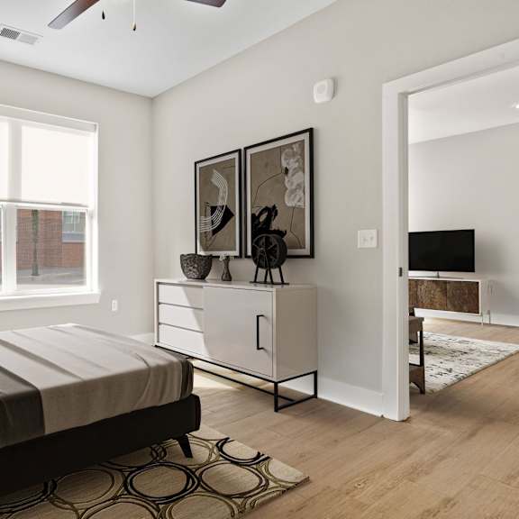 A bedroom with a bed, a dresser, and a window.