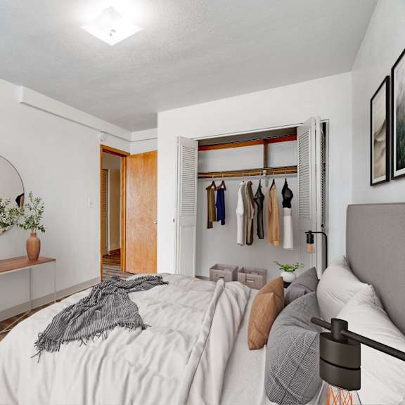 A bedroom with a bed, a mirror, a dresser, and a basket.