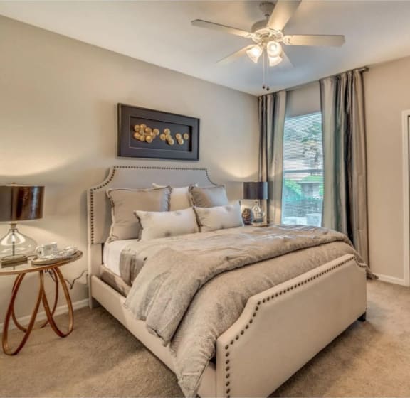 a bedroom with a bed and a ceiling fan