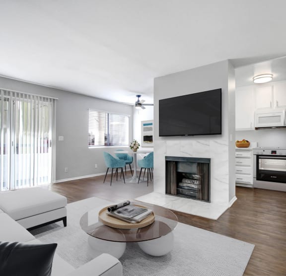 a white bedroom with a large bed and a tv