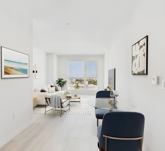 A modern living room with a dining table and chairs.