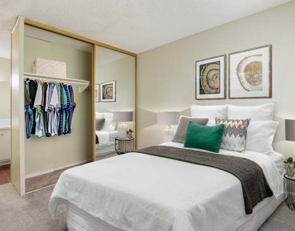 A bedroom with a large bed and a wardrobe.