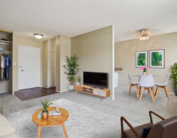 A living room with a brown leather chair and a wooden coffee table.